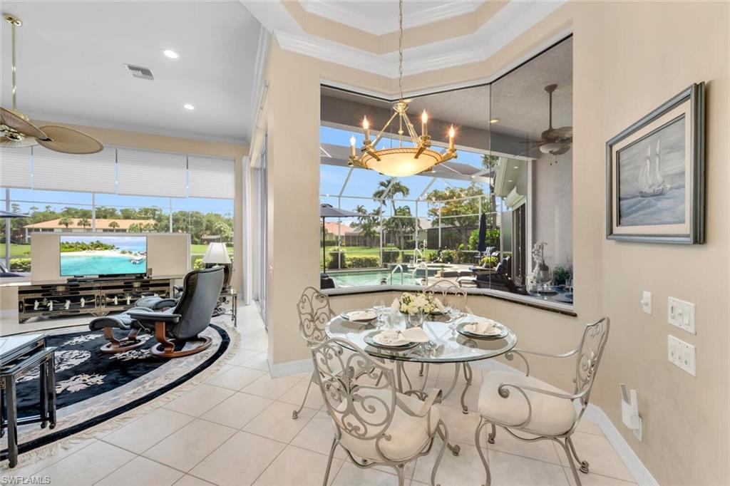 1624 Manchester Court Naples, FL 34109 - Photo 8 of 30 a view of a dining room with furniture large window and outside view
