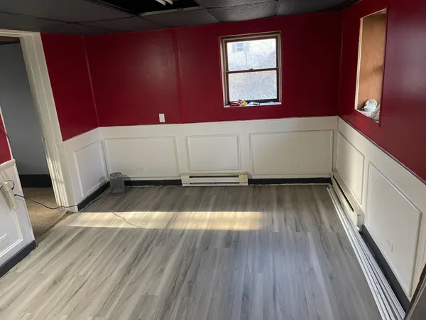 a view of a room with wooden floor and staircase