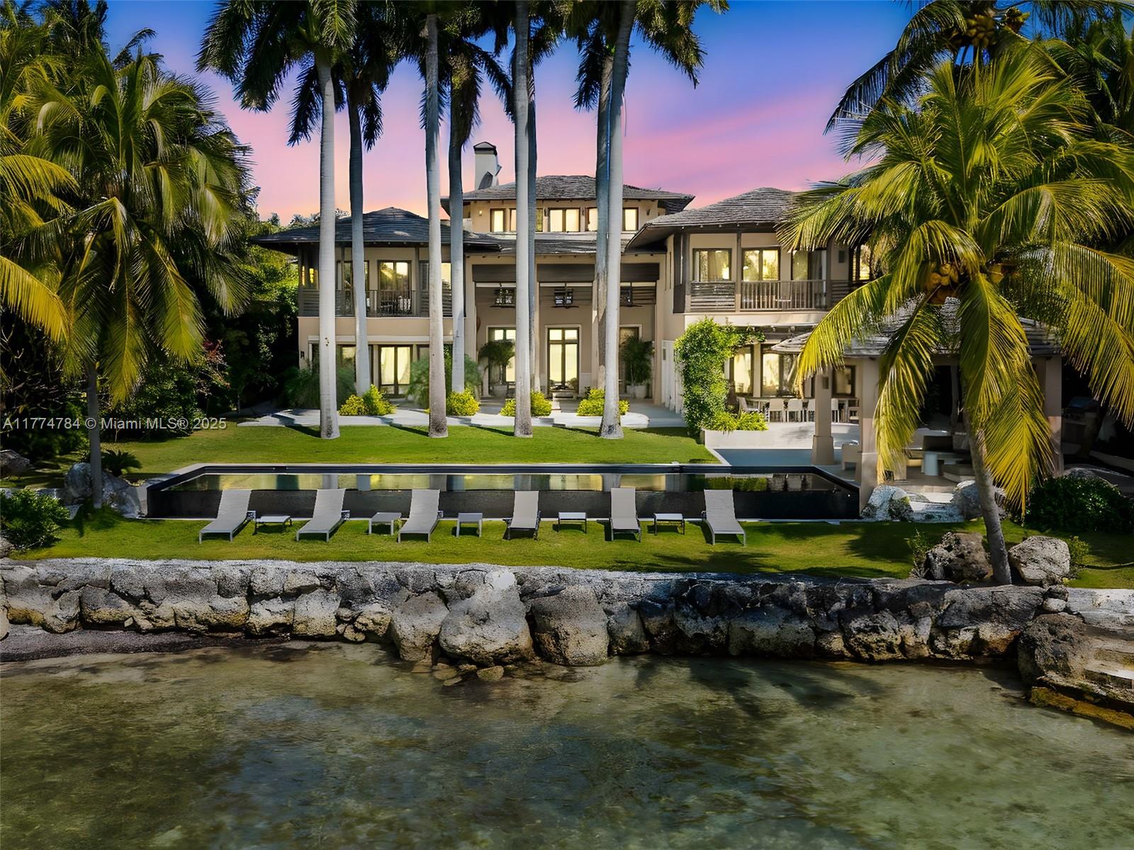 9 Harbor Point Key Biscayne, FL 33149 - Photo 29 of 88 front view of a house with a yard and potted plants