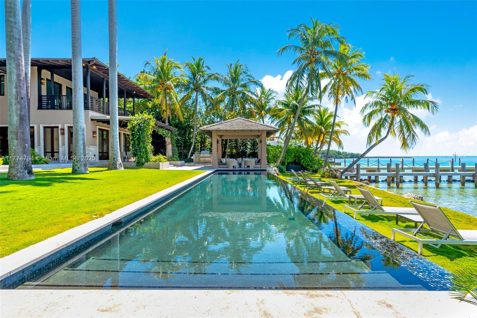 9 Harbor Point Key Biscayne, FL 33149 - Photo 3 of 88 a view of a swimming pool with a garden