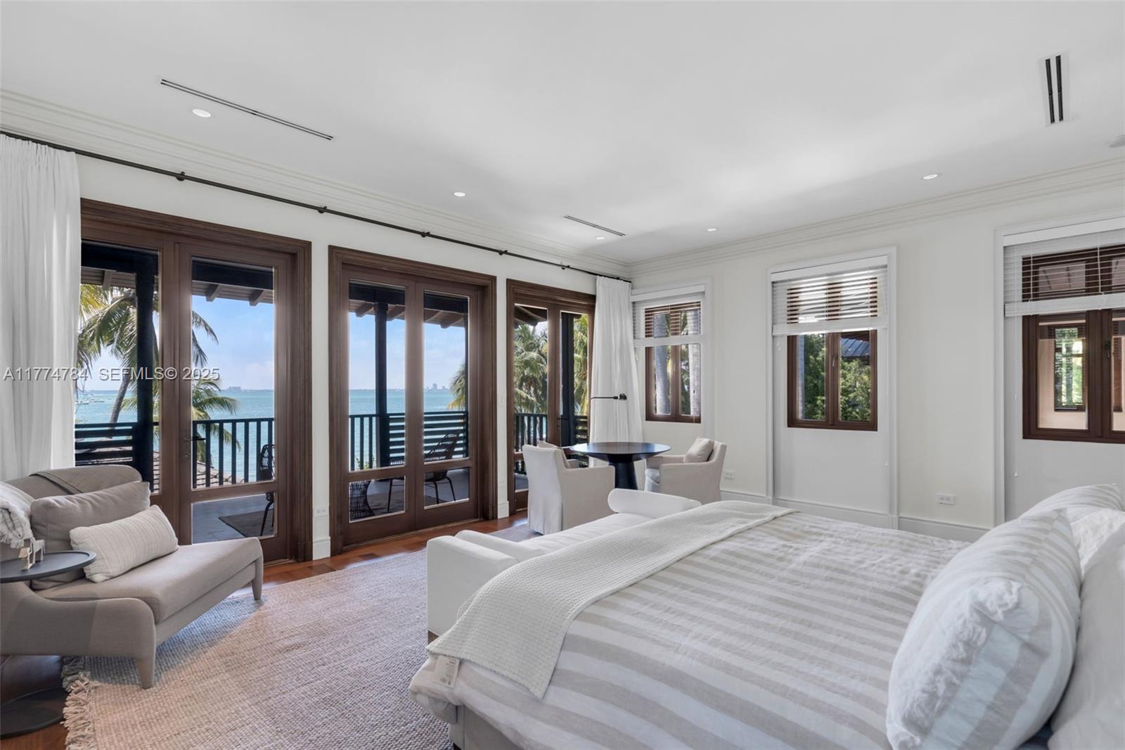 9 Harbor Point Key Biscayne, FL 33149 - Photo 32 of 88 a bedroom with a large bed and a window