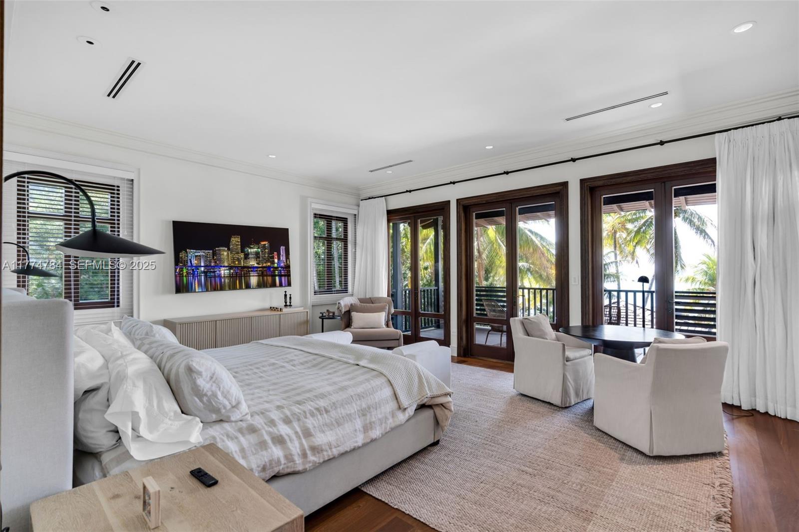 9 Harbor Point Key Biscayne, FL 33149 - Photo 33 of 88 a bedroom with a large bed and a large window