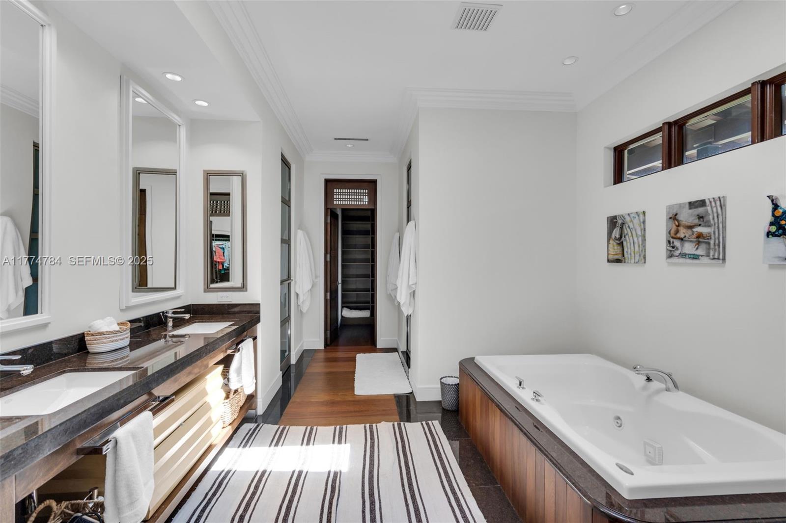 9 Harbor Point Key Biscayne, FL 33149 - Photo 34 of 88 a bathroom with a granite countertop double vanity sink a mirror and a bathtub