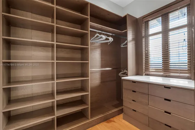 a bedroom with furniture and large windows