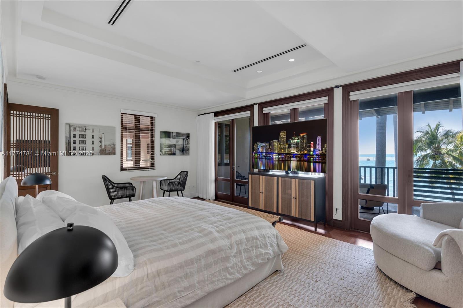 9 Harbor Point Key Biscayne, FL 33149 - Photo 37 of 88 a bedroom with a large bed and a couch