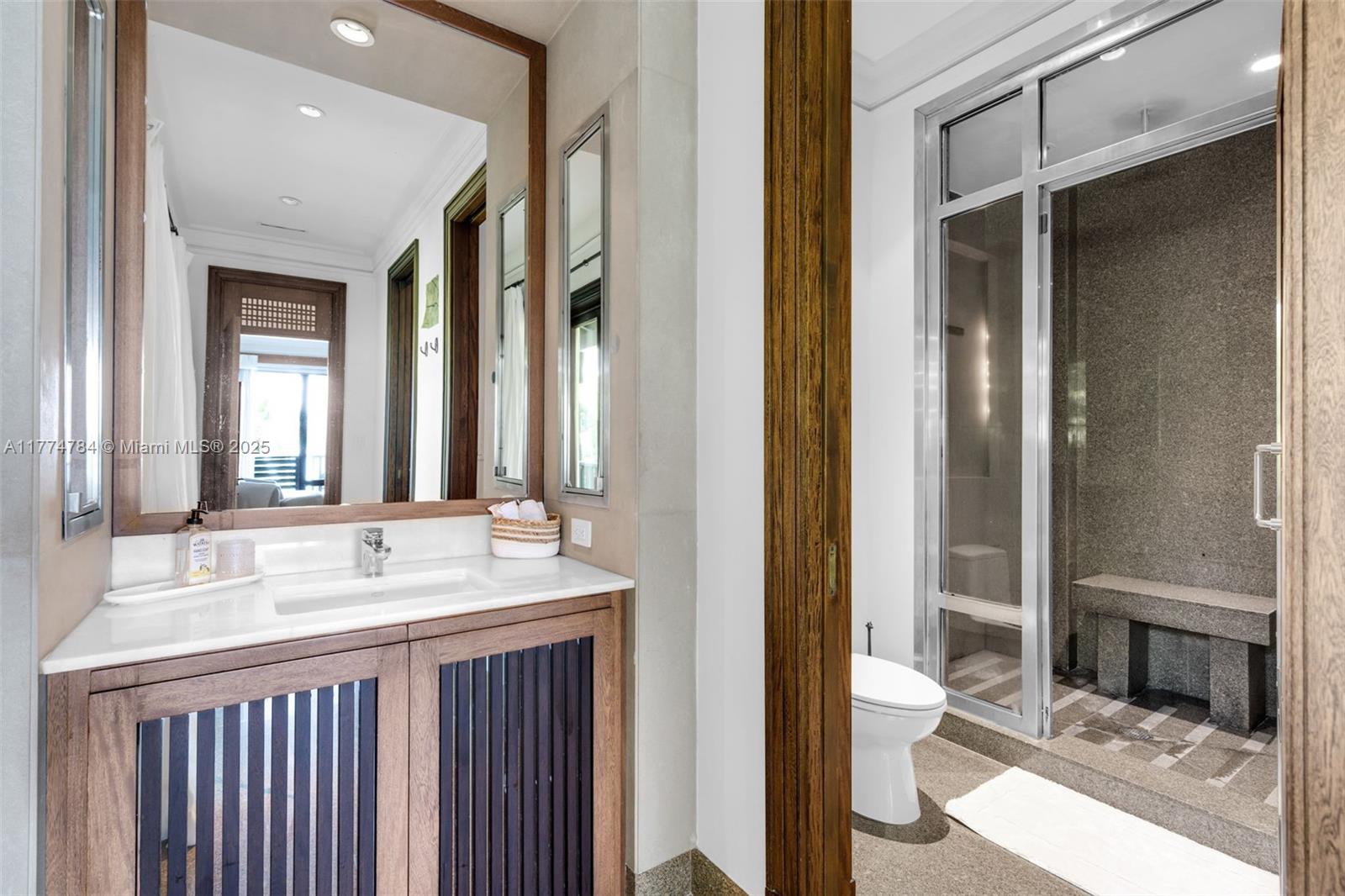 9 Harbor Point Key Biscayne, FL 33149 - Photo 39 of 88 a bathroom with a double vanity sink and a mirror