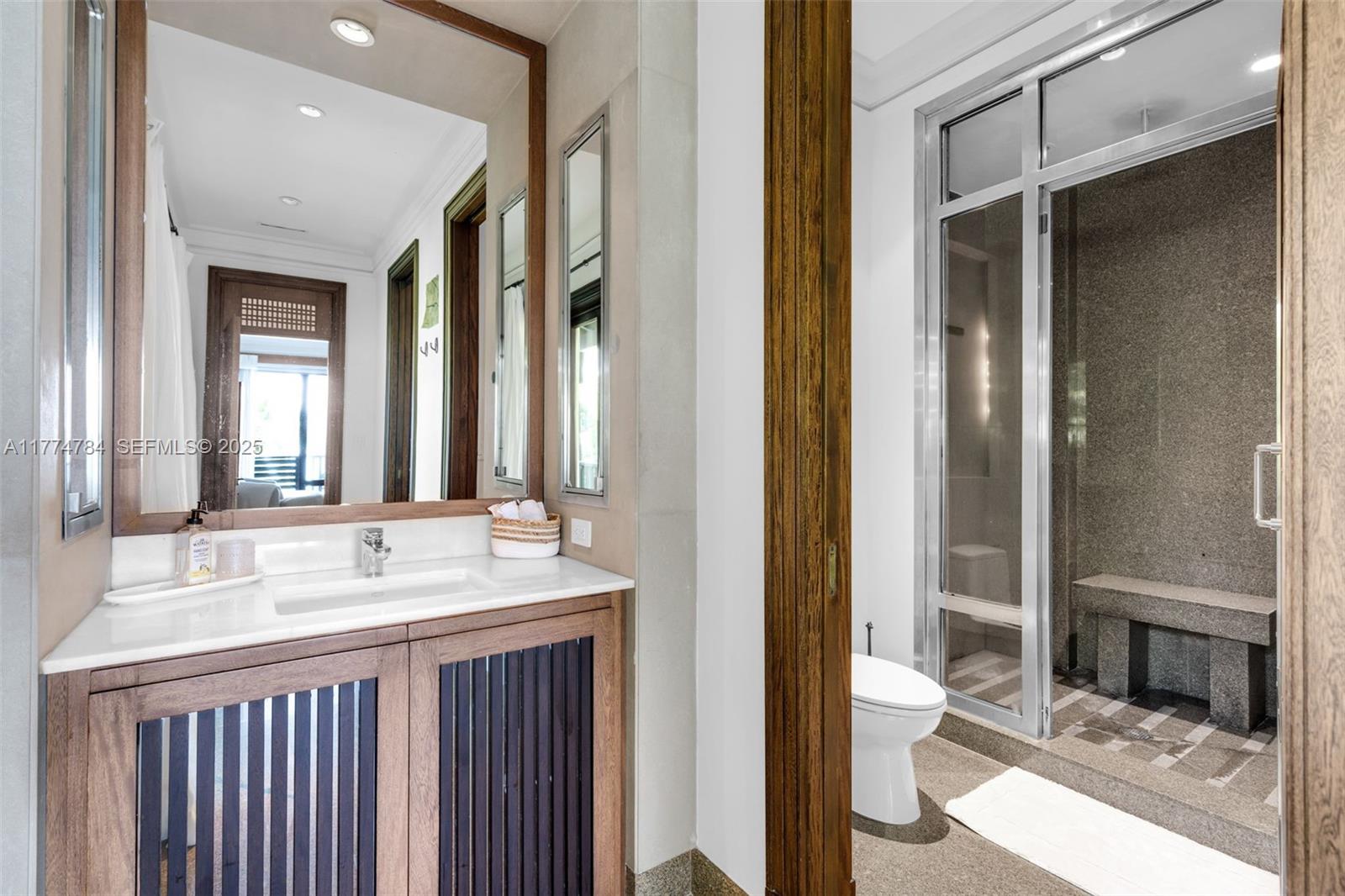 9 Harbor Point Key Biscayne, FL 33149 - Photo 39 of 88 a bathroom with a double vanity sink and a mirror