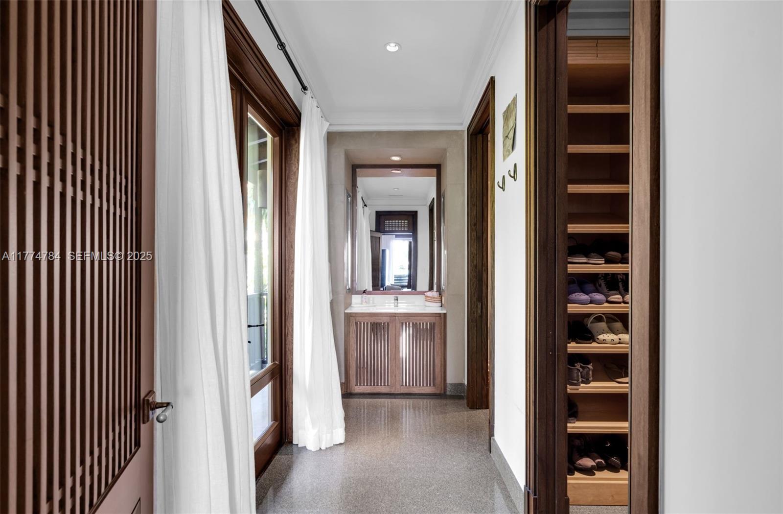 9 Harbor Point Key Biscayne, FL 33149 - Photo 40 of 88 a view of a hallway with wooden shelves