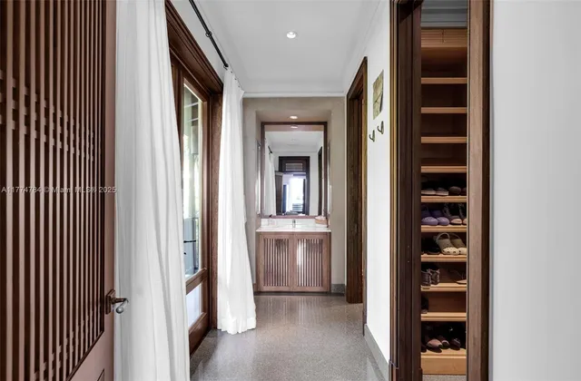 a balcony with chairs and with potted plants
