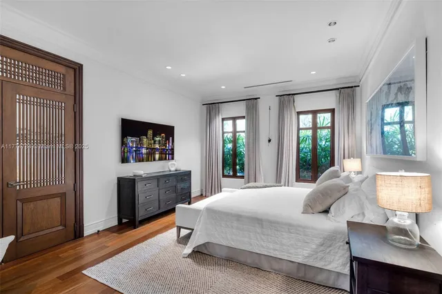 a view of a room with a chandelier fan and wooden floor