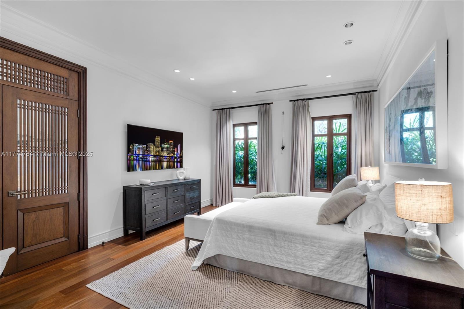 9 Harbor Point Key Biscayne, FL 33149 - Photo 47 of 88 a spacious bedroom with a bed and wooden floor