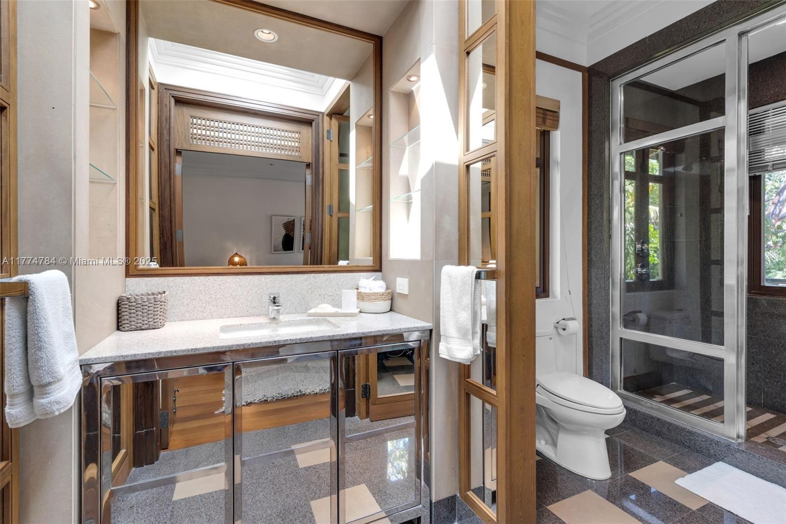 9 Harbor Point Key Biscayne, FL 33149 - Photo 50 of 88 a bathroom with a toilet a sink and a mirror