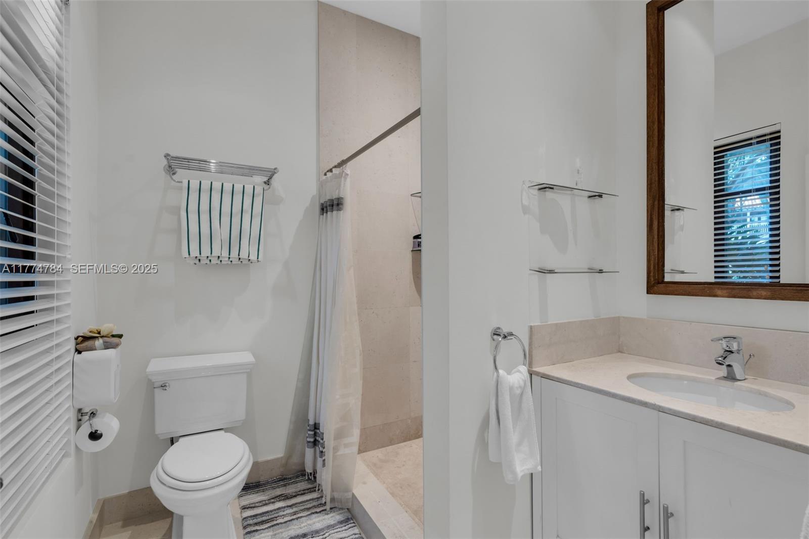 9 Harbor Point Key Biscayne, FL 33149 - Photo 57 of 88 a bathroom with a granite countertop sink toilet and shower