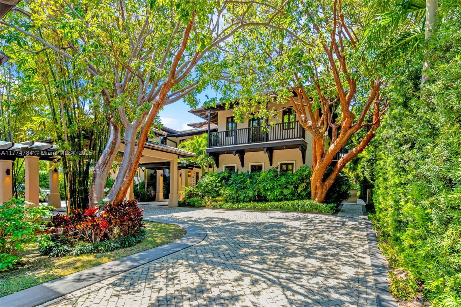 9 Harbor Point Key Biscayne, FL 33149 - Photo 6 of 88 a front view of a house with a yard and potted plants