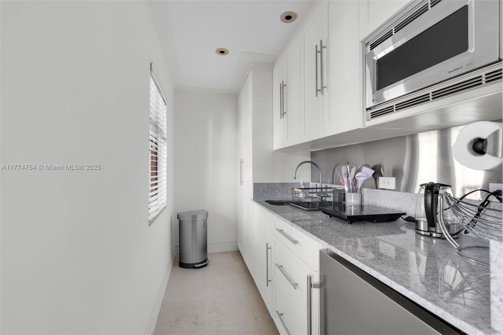 9 Harbor Point Key Biscayne, FL 33149 - Photo 71 of 88 a kitchen with stainless steel appliances granite countertop a sink and a microwave