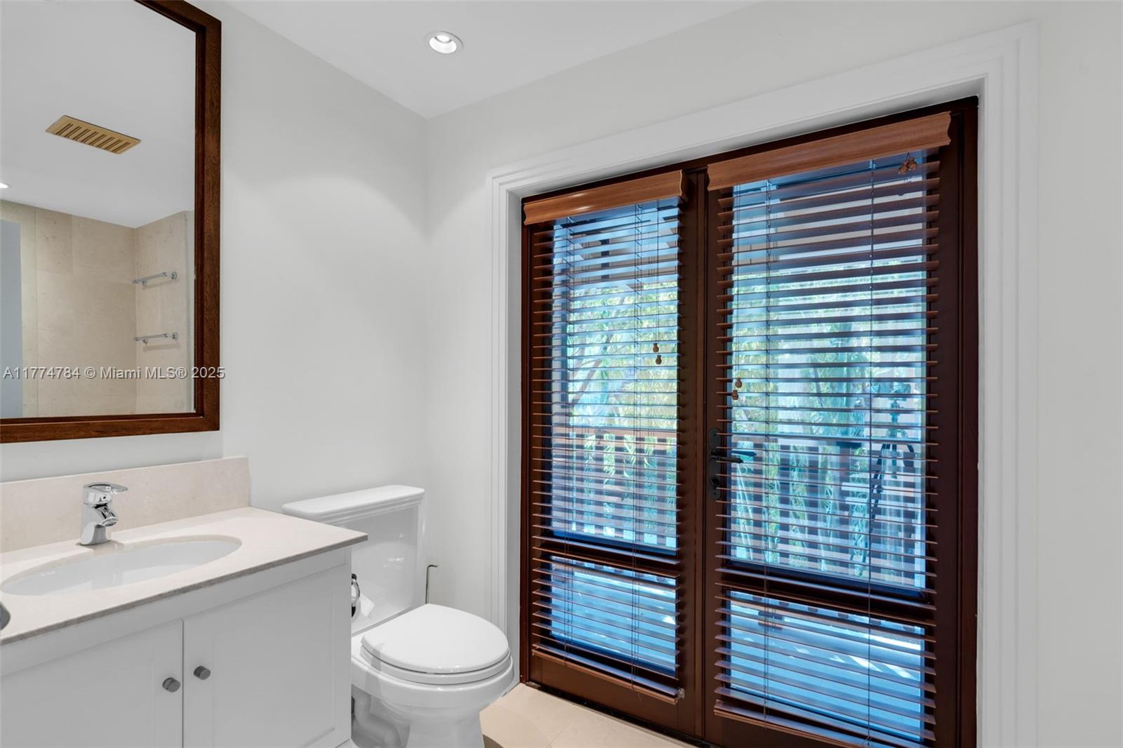 9 Harbor Point Key Biscayne, FL 33149 - Photo 72 of 88 a bathroom with a toilet a sink and a mirror