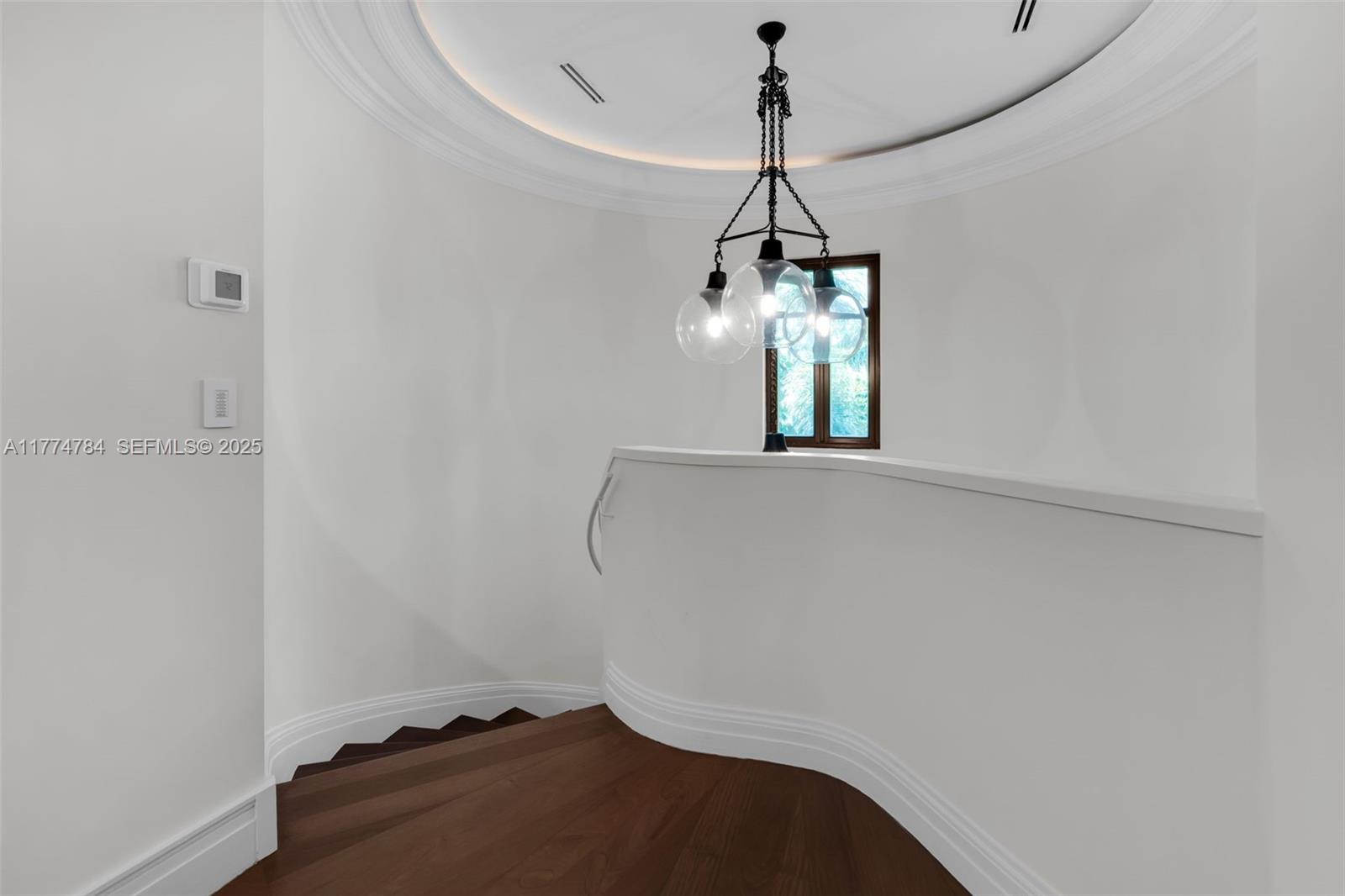 9 Harbor Point Key Biscayne, FL 33149 - Photo 75 of 88 a view of a room with a chandelier fan and wooden floor