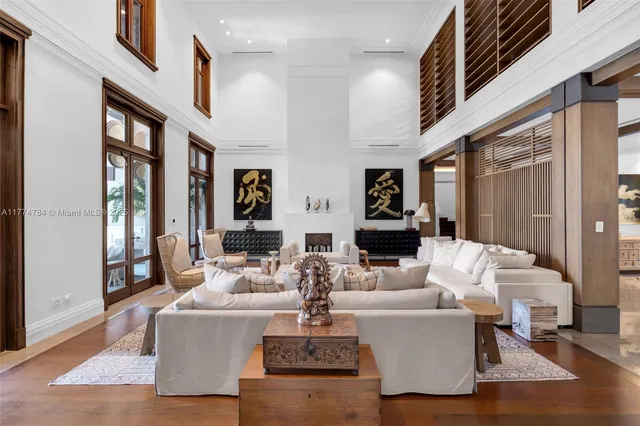 a view of a dining room with furniture large windows and wooden floor