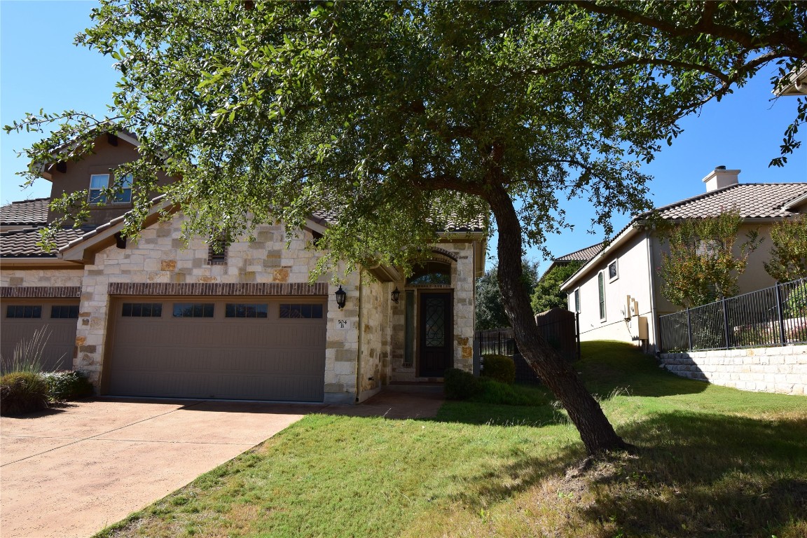 504 Hummingbird Lane, Unit B Austin, TX 78734 - Photo 1 of 1 a front view of a house with a yard and garage
