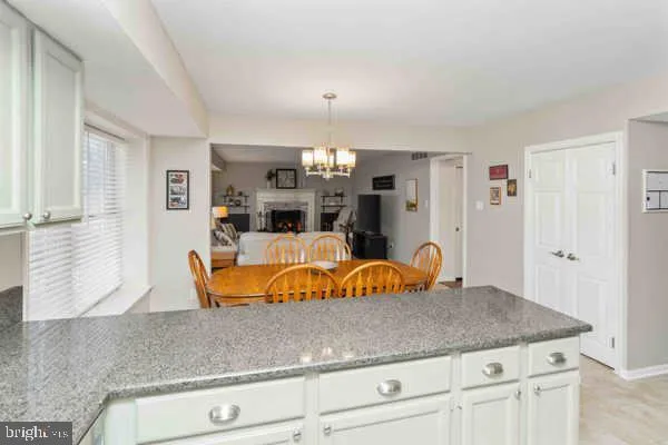 a hallway with a couch and a dresser with wooden floor