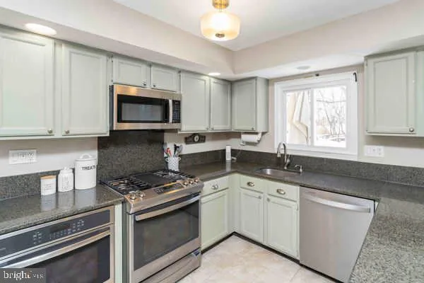 a living room with furniture a window and wooden floor