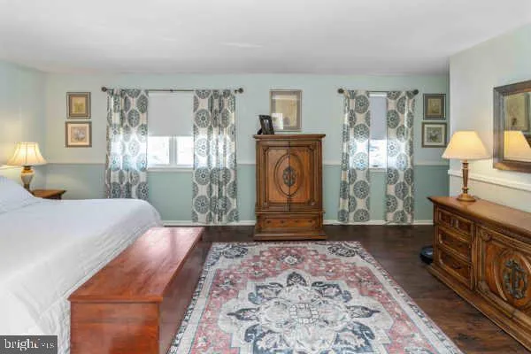 a bedroom with a bed and a lamp on table