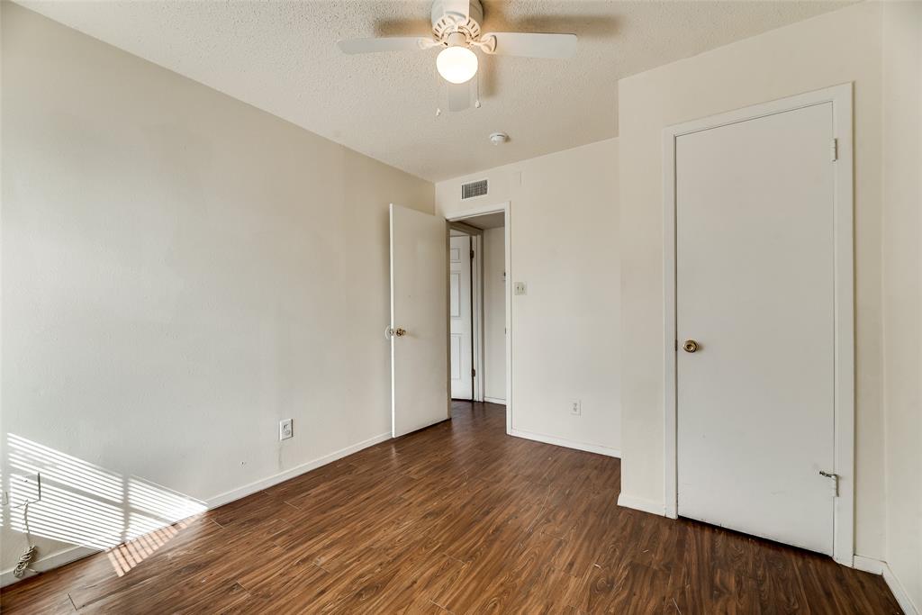 106 East Cedar Street, Unit 12 Arlington, TX 76011 - Photo 16 of 18 a view of an empty room with wooden floor