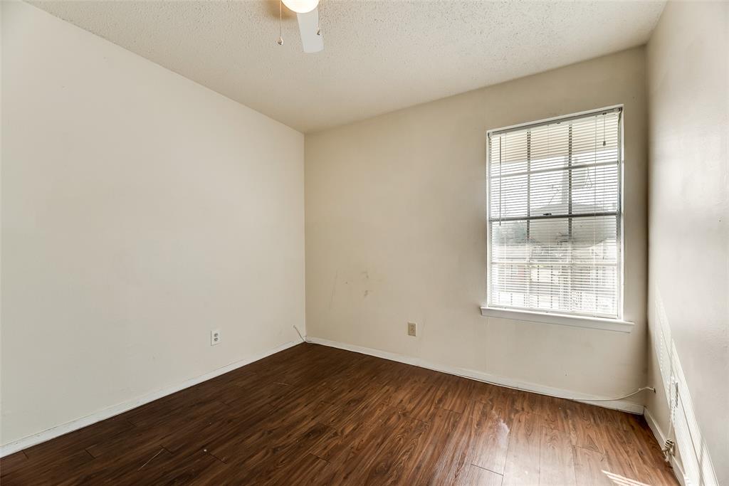 106 East Cedar Street, Unit 12 Arlington, TX 76011 - Photo 17 of 18 an empty room with wooden floor and windows