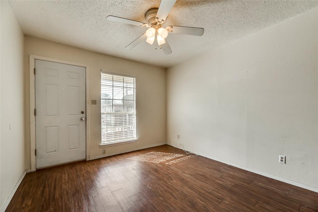 106 East Cedar Street, Unit 12 Arlington, TX 76011 - Photo 5 of 18 wooden floor in an empty room with a window