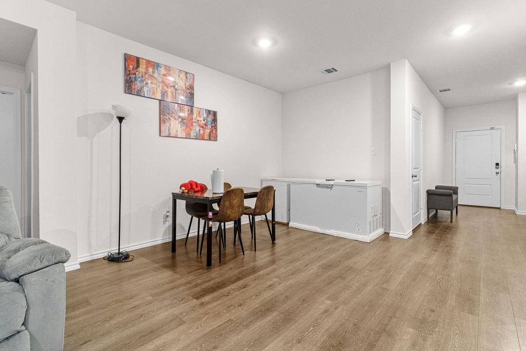 2928 Roper Street Royse City, TX 75189 - Photo 12 of 26 a view of a dining room with furniture and wooden floor