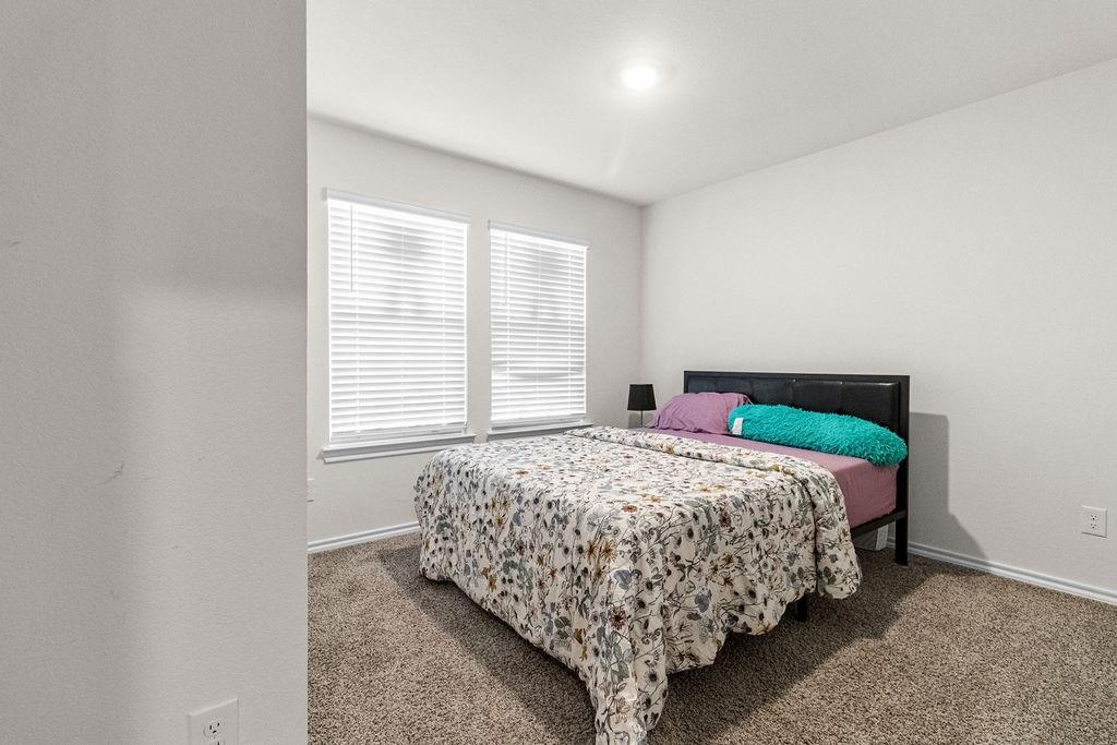 2928 Roper Street Royse City, TX 75189 - Photo 13 of 26 a bedroom with a bed and a window