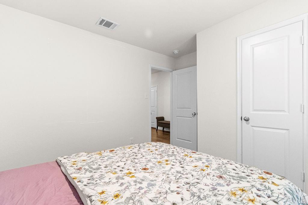 2928 Roper Street Royse City, TX 75189 - Photo 14 of 26 a bedroom with a bed and a bed