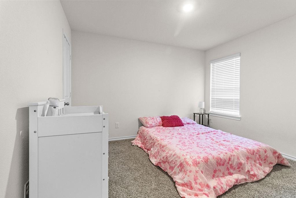2928 Roper Street Royse City, TX 75189 - Photo 16 of 26 a bedroom with a bed and a white cabinet