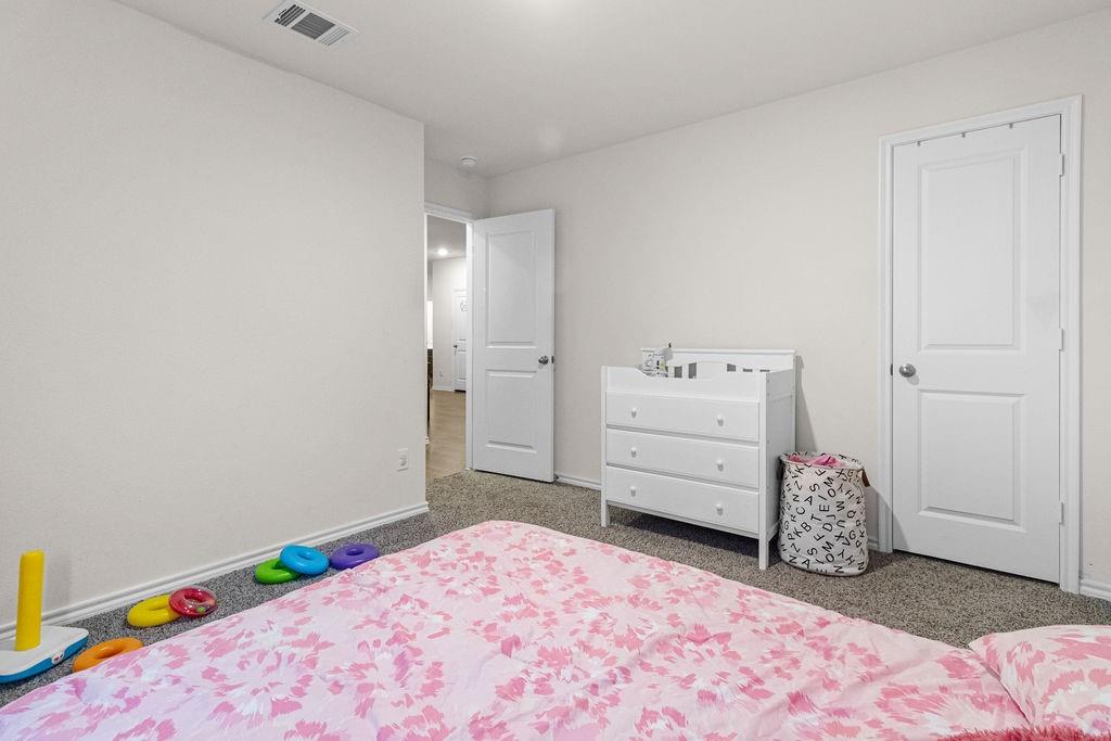 2928 Roper Street Royse City, TX 75189 - Photo 17 of 26 a bedroom with a bed and a window