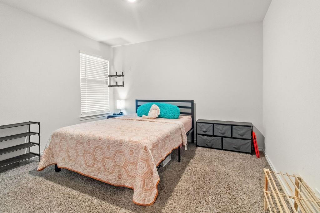 2928 Roper Street Royse City, TX 75189 - Photo 18 of 26 a bedroom with a bed and a window