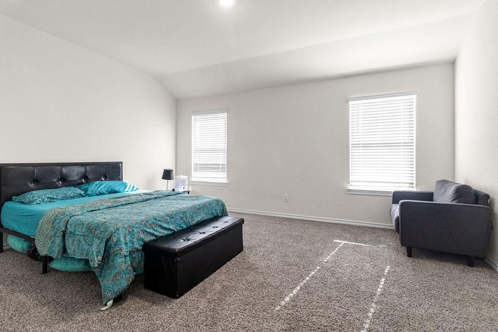 2928 Roper Street Royse City, TX 75189 - Photo 20 of 26 a bedroom with a bed and window