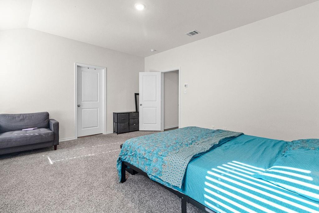 2928 Roper Street Royse City, TX 75189 - Photo 21 of 26 a bedroom with a bed and a couch