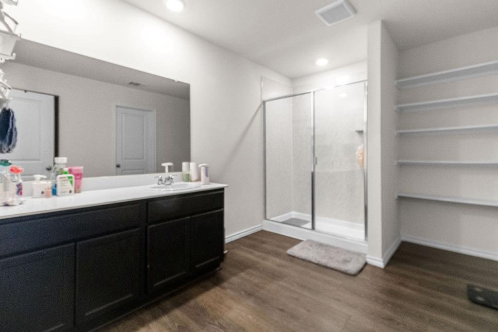 2928 Roper Street Royse City, TX 75189 - Photo 22 of 26 a bathroom with a double vanity sink and mirror