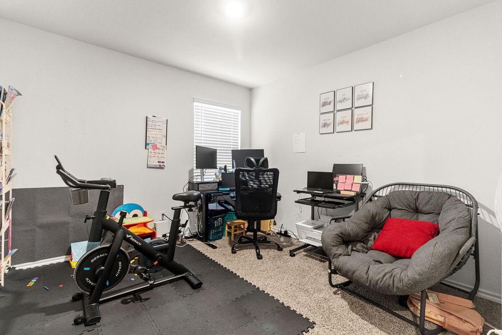 2928 Roper Street Royse City, TX 75189 - Photo 23 of 26 a view of a workspace with furniture and a livingroom