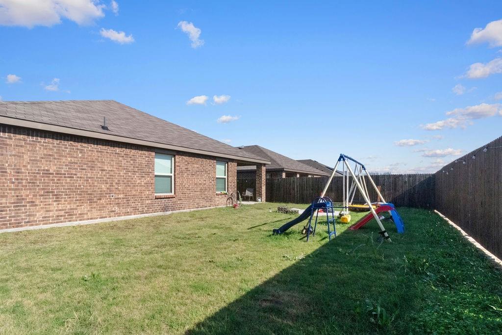 2928 Roper Street Royse City, TX 75189 - Photo 26 of 26 a view of a house with a backyard