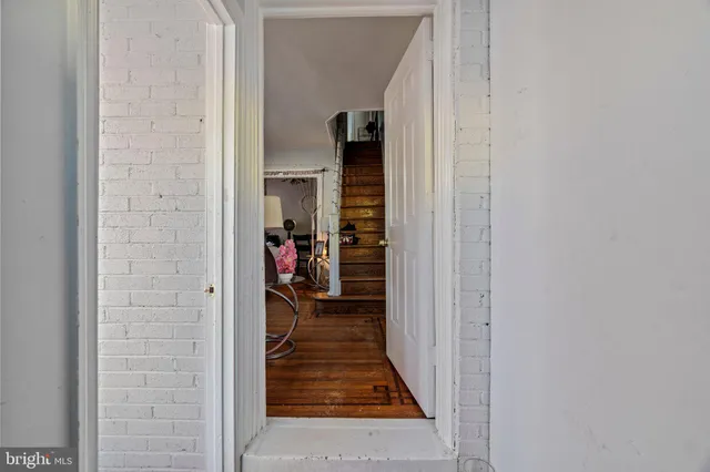 a view of a hallway and a livingroom with furniture