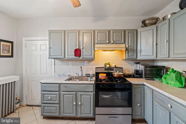 a kitchen with granite countertop a sink cabinets and window