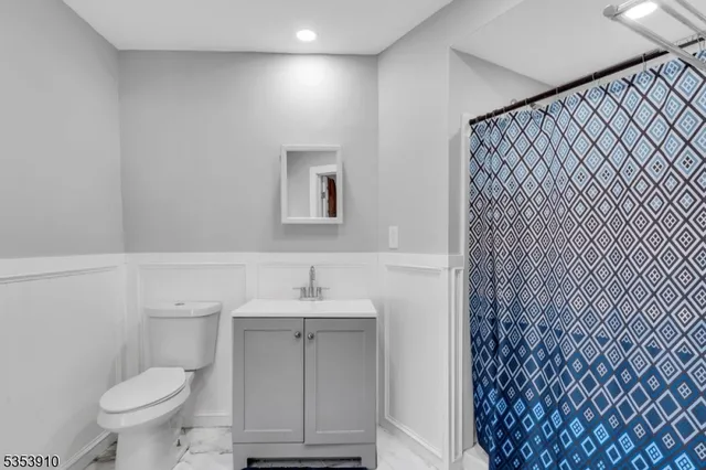 a bathroom with a sink toilet and mirror