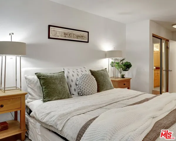 a bedroom with bed and a lamp