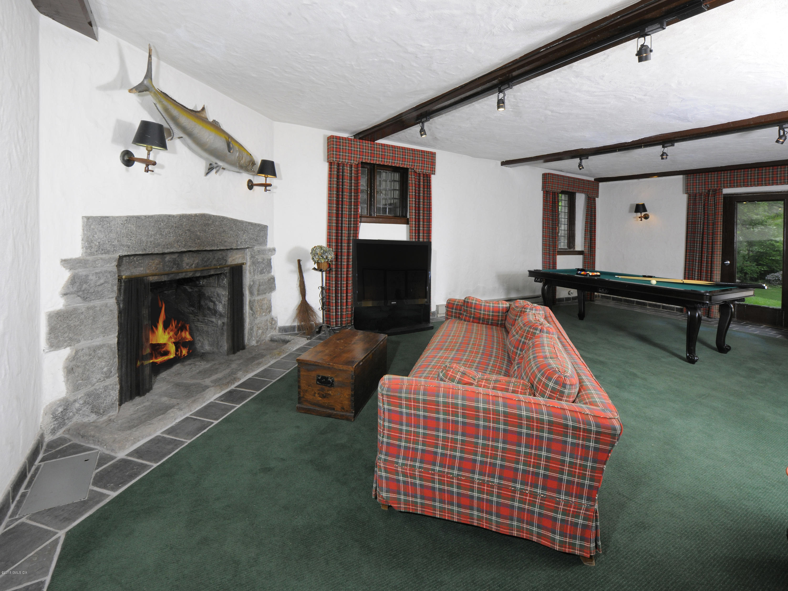 9 Frost Road Greenwich, CT 06830 - Photo 15 of 29 a bedroom with a bed and a fireplace