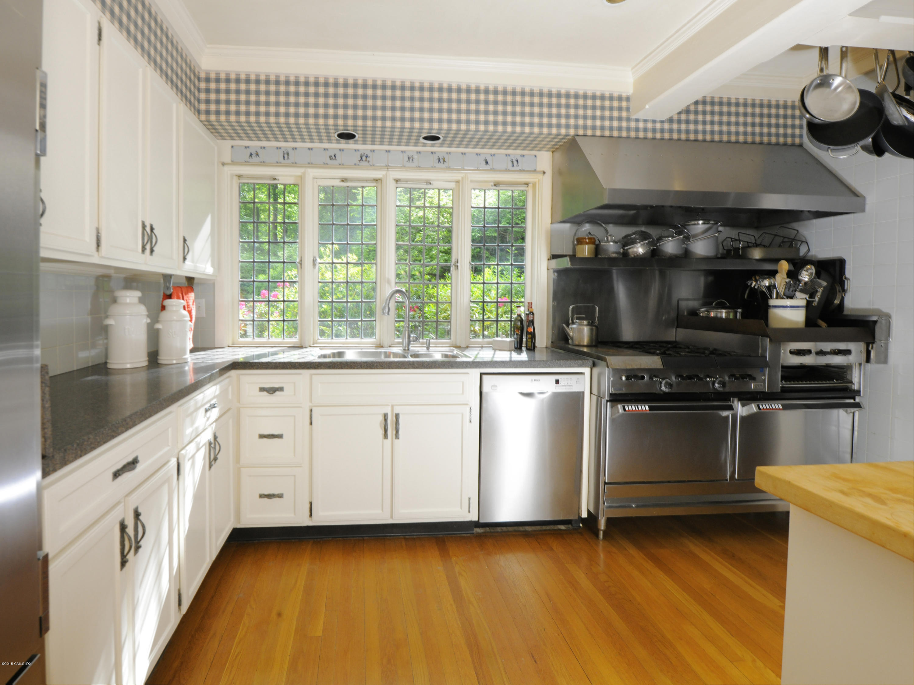 9 Frost Road Greenwich, CT 06830 - Photo 9 of 29 a kitchen with granite countertop white cabinets and white appliances
