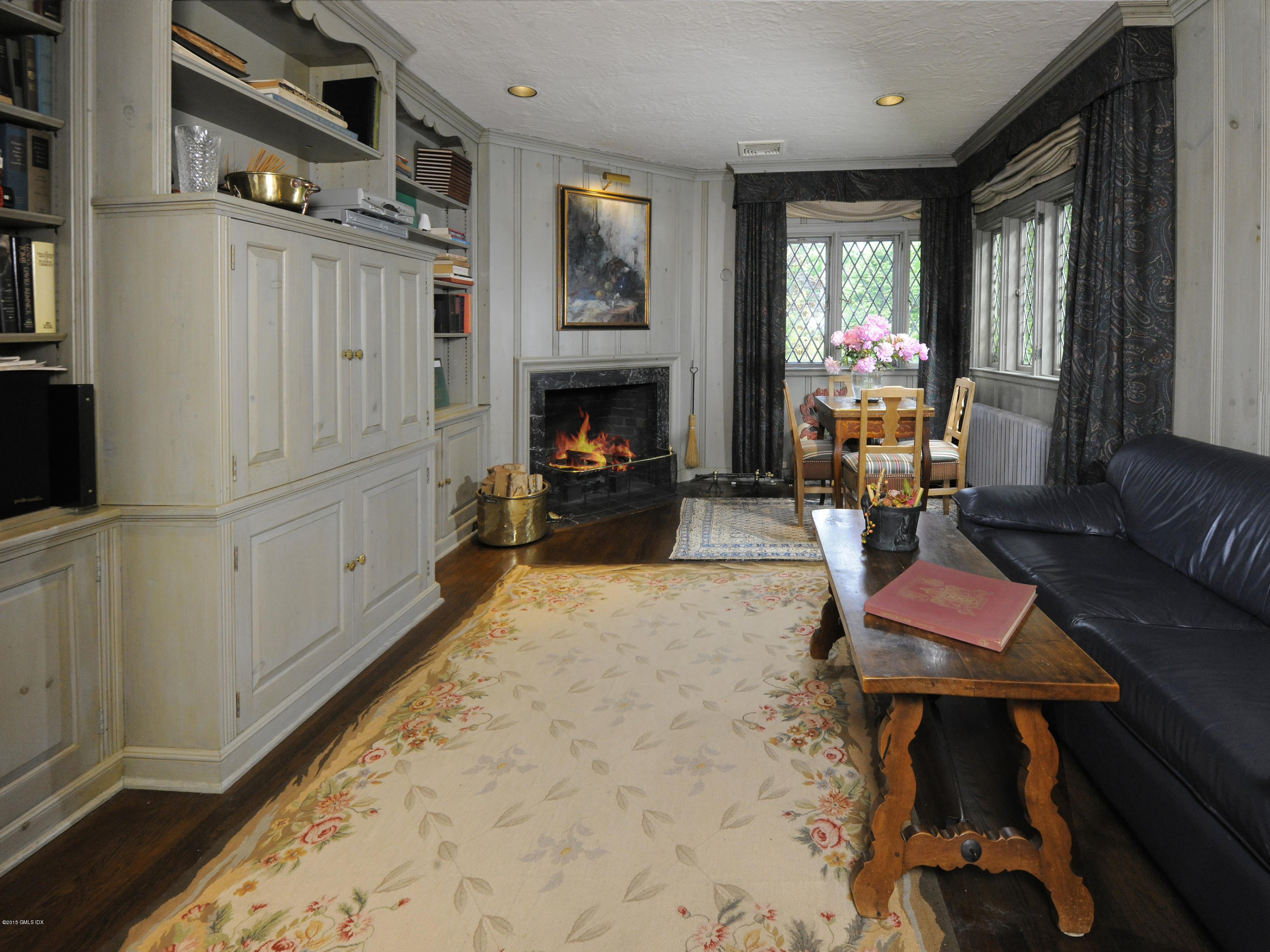 9 Frost Road Greenwich, CT 06830 - Photo 10 of 29 a living room with furniture a fireplace and a large window