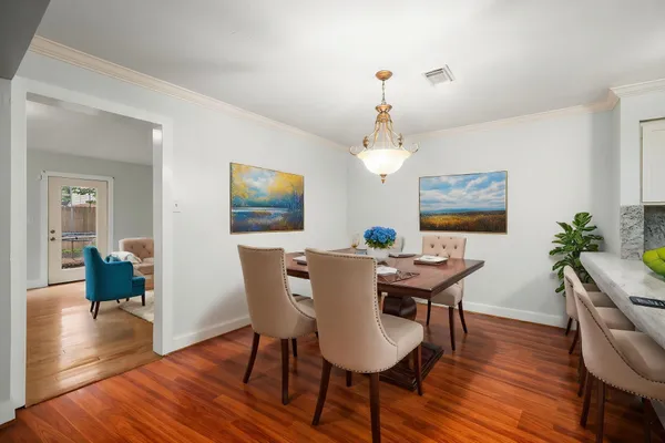 a view of a dining room with furniture window and wooden floor