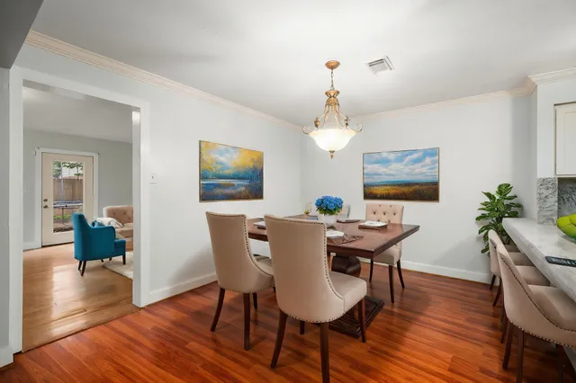 a view of a dining room with furniture window and wooden floor