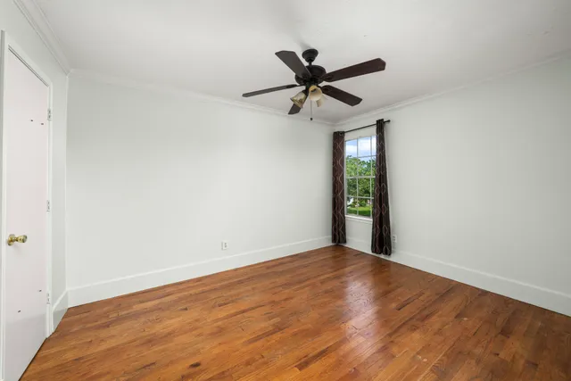 a view of an empty room and wooden floor